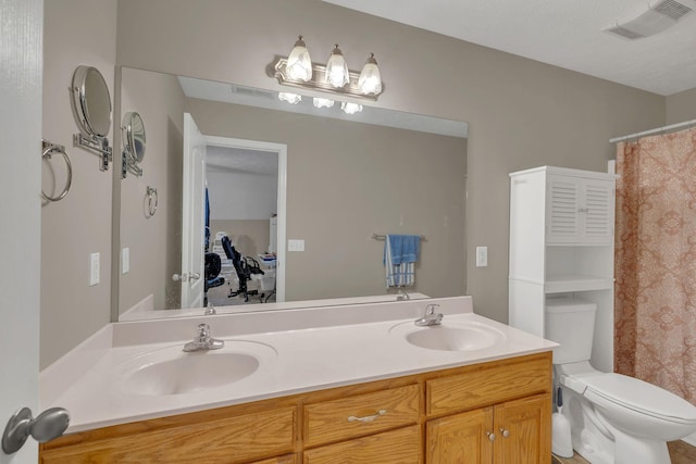full bathroom with double vanity, toilet, visible vents, and a sink
