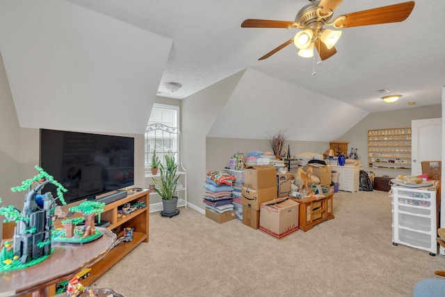 game room with baseboards, carpet, lofted ceiling, a textured ceiling, and a ceiling fan