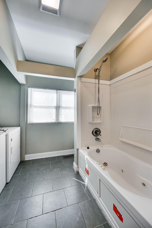 4509 Wyoming Ave, Nashville, TN 37209 - bathroom with baseboards, visible vents, a combined bath / shower with jetted tub, washer and dryer, and tile patterned floors