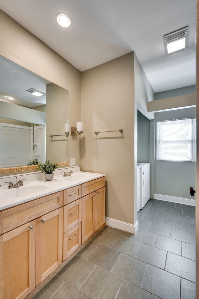 4509 Wyoming Ave, Nashville, TN 37209 - bathroom featuring a sink, baseboards, separate washer and dryer, and double vanity