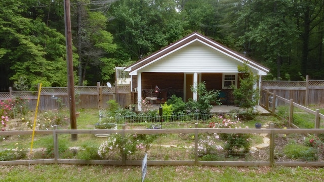 197 Midway Rd, Sewanee, TN 37375 - back of property featuring a fenced backyard, a wooded view, and covered porch