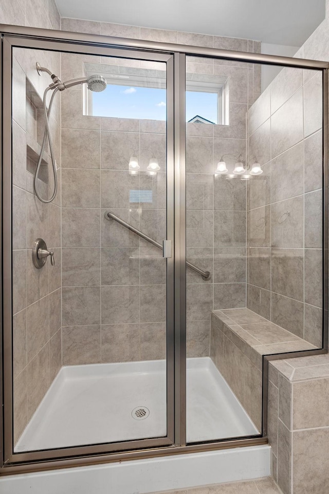 full bathroom featuring a healthy amount of sunlight and a shower stall