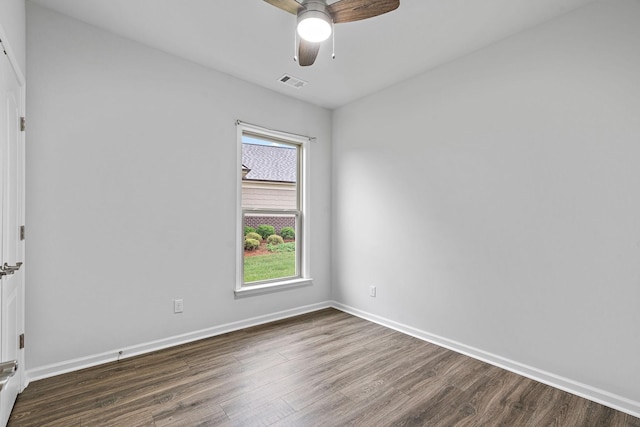 unfurnished room with baseboards, visible vents, wood finished floors, and a ceiling fan