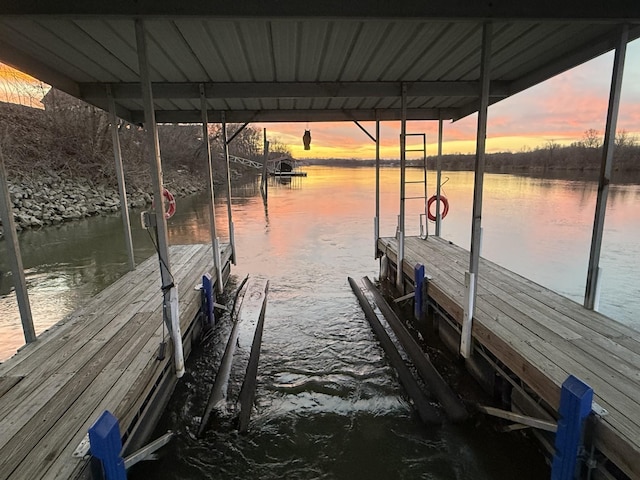 dock area featuring boat lift and a water view