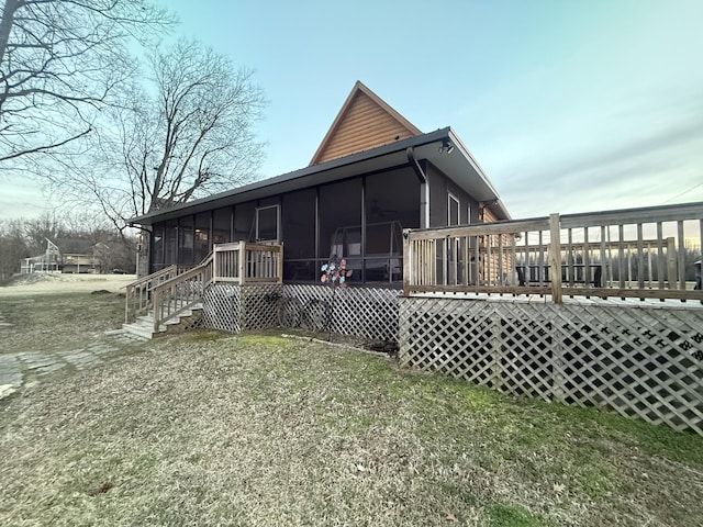 back of house featuring a deck and a sunroom