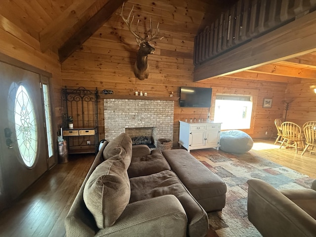 living room with wooden walls, wood finished floors, beamed ceiling, and high vaulted ceiling