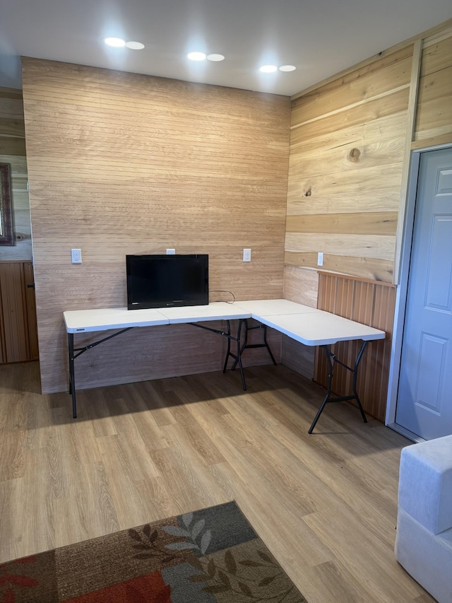 misc room with wooden walls and wood finished floors