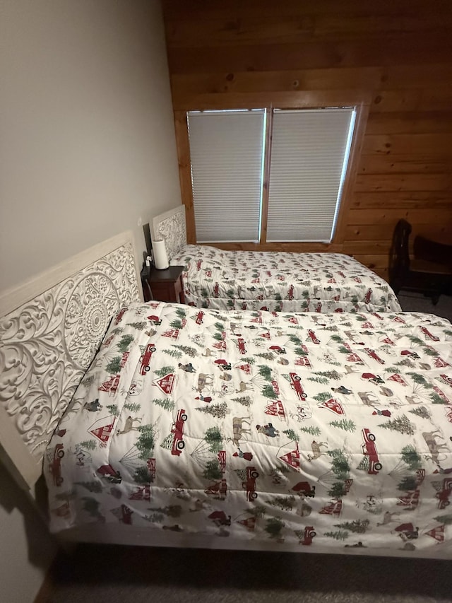 bedroom featuring wooden walls