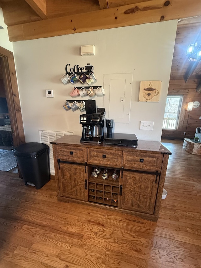bar featuring wooden walls and wood finished floors