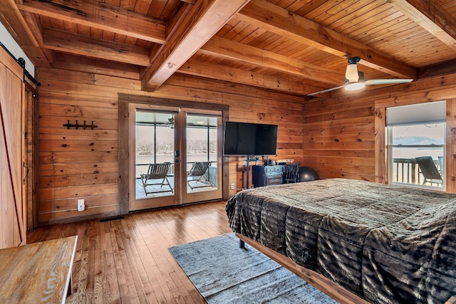 bedroom featuring access to exterior, wooden walls, french doors, and wood-type flooring