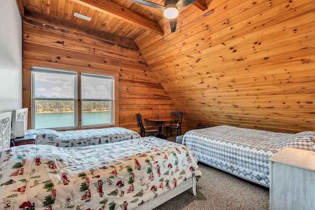 carpeted bedroom with wooden ceiling, lofted ceiling with beams, a water view, and wood walls