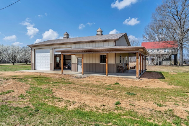rear view of property with a porch, board and batten siding, and a yard
