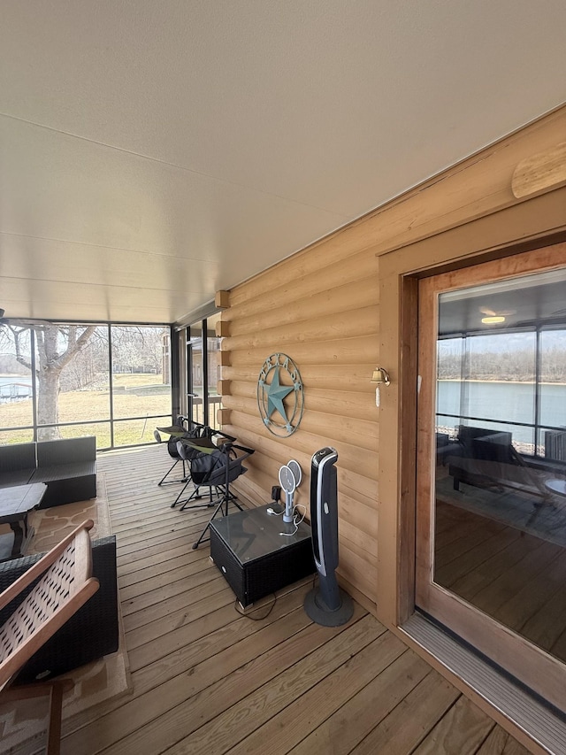 wooden terrace featuring a water view