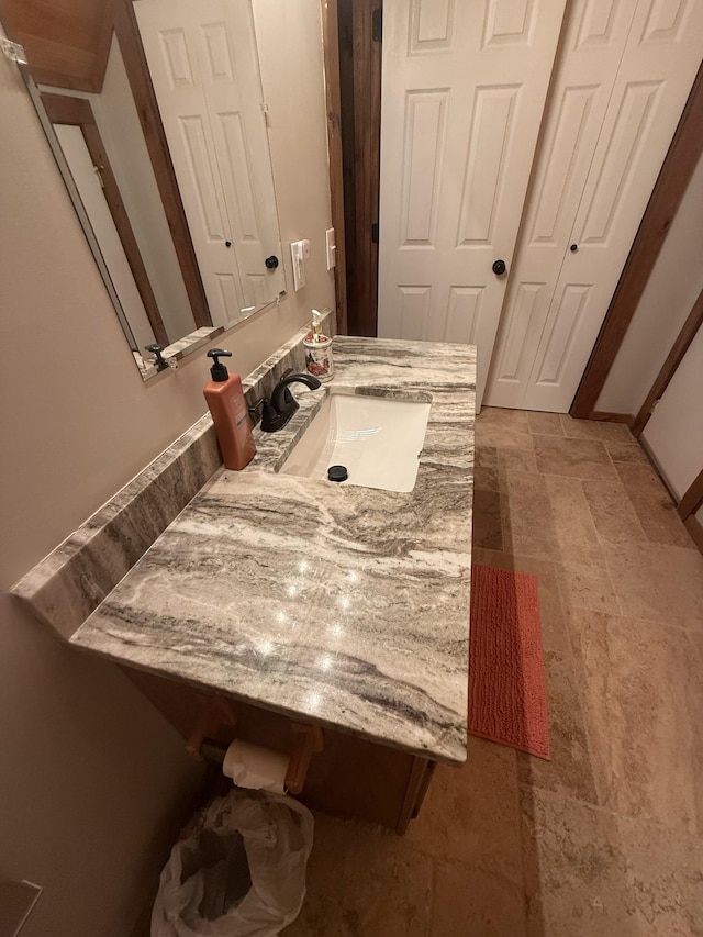 bathroom with vanity and stone finish flooring