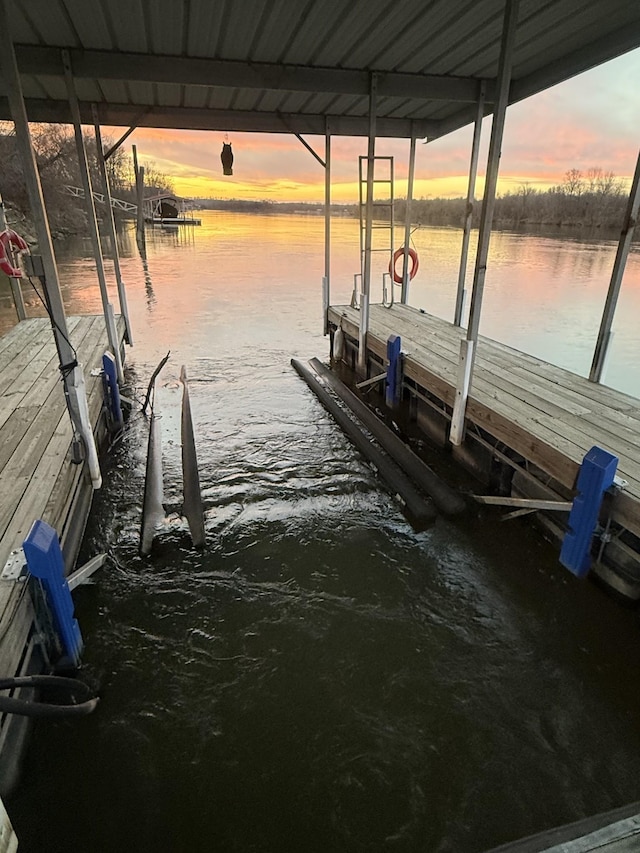 dock area with a water view and boat lift