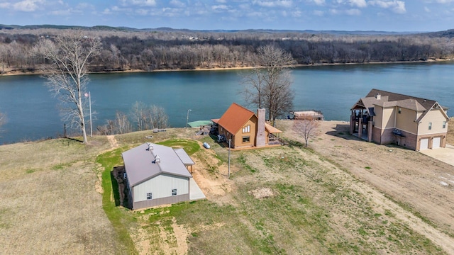 aerial view with a forest view and a water view