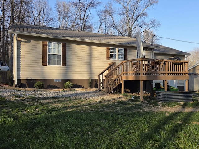 view of front of property featuring a front lawn, stairs, metal roof, a deck, and crawl space