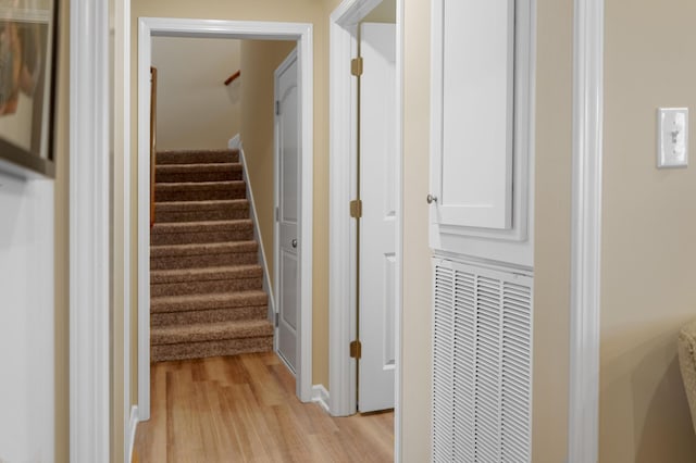 staircase with visible vents and wood finished floors