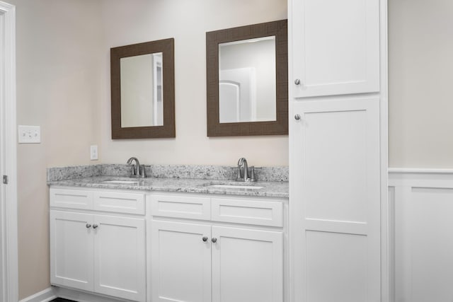 bathroom with double vanity and a sink