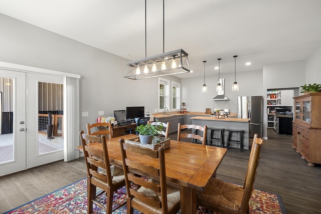 dining area with french doors and dark wood-type flooring