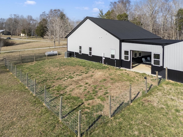 view of home's exterior featuring an outbuilding, a carport, a pole building, and fence