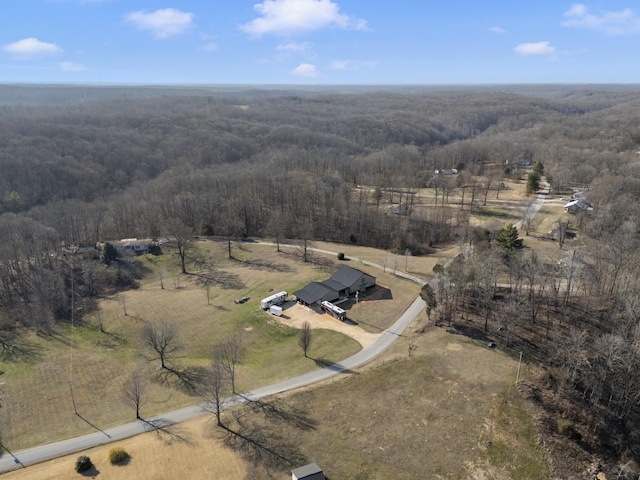 drone / aerial view featuring a rural view and a forest view