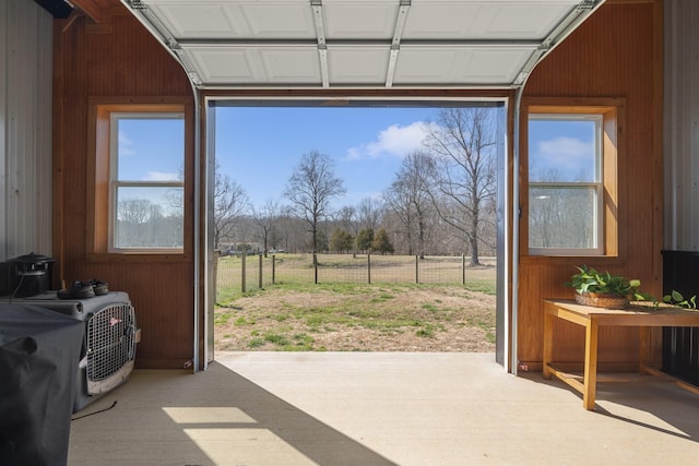 entryway featuring wooden walls and a healthy amount of sunlight