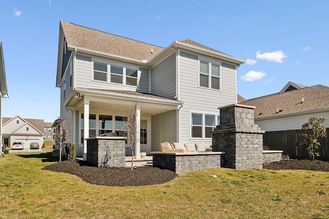 rear view of property featuring fence, a lawn, and a patio area