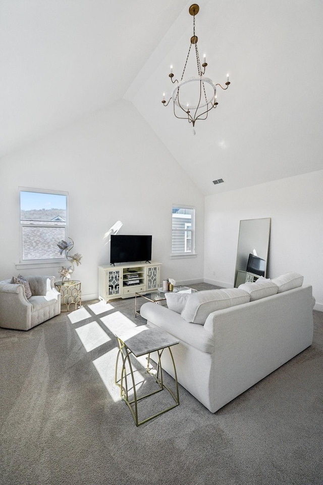 living room featuring a notable chandelier, carpet floors, plenty of natural light, and visible vents