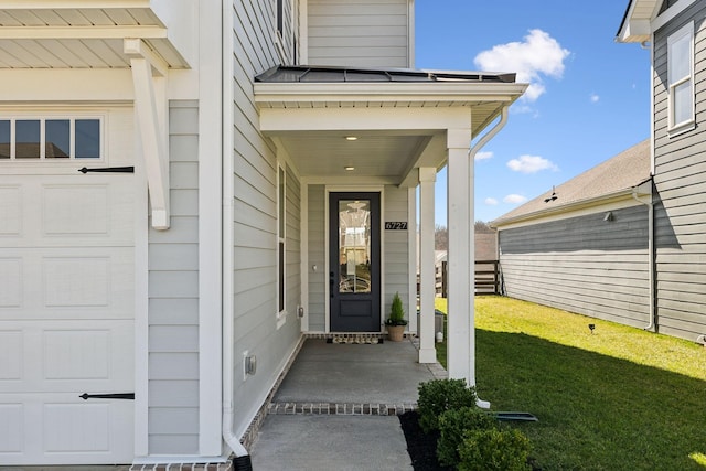property entrance with a lawn