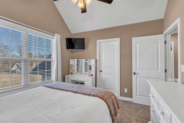 bedroom featuring carpet flooring, baseboards, a ceiling fan, and vaulted ceiling