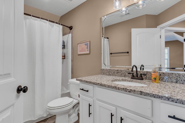 bathroom featuring visible vents, toilet, vanity, and shower / bath combo