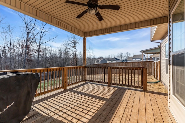 deck with area for grilling, fence, and ceiling fan