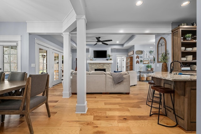 living room with recessed lighting, french doors, light wood-style floors, decorative columns, and ceiling fan