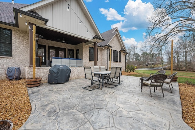 view of patio with outdoor dining area and grilling area