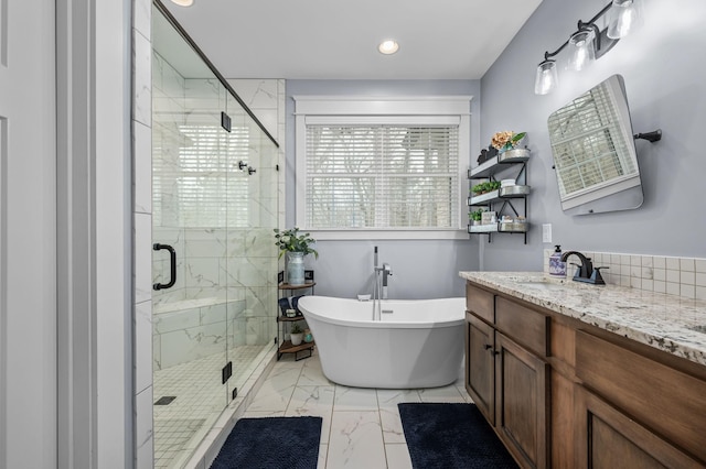 full bathroom with vanity, a soaking tub, marble finish floor, and a shower stall