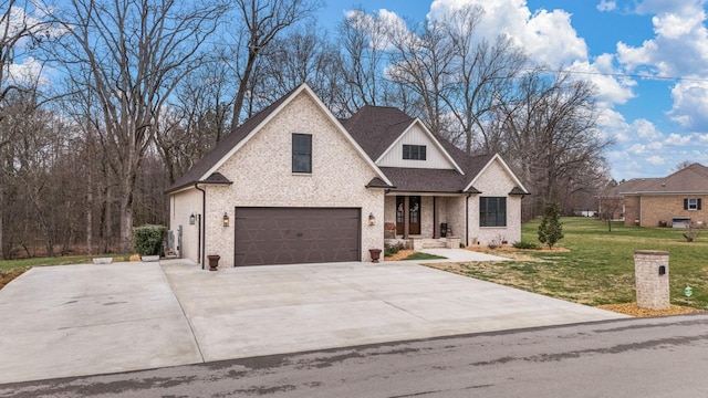 view of front of property featuring brick siding, an attached garage, concrete driveway, and a front yard