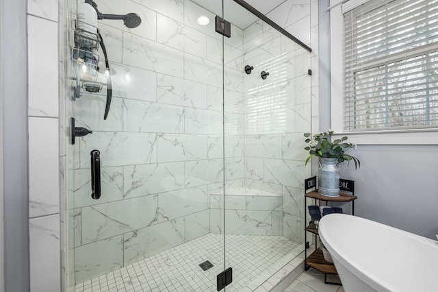 full bathroom with a freestanding bath and a stall shower