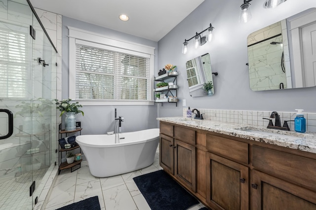 full bathroom featuring a shower stall, a wealth of natural light, and a sink