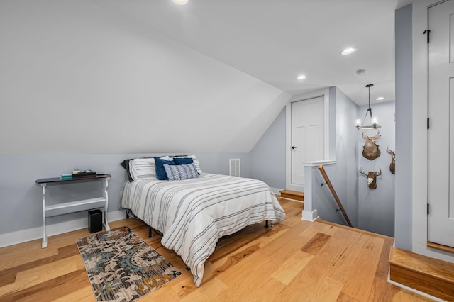 bedroom featuring visible vents, baseboards, recessed lighting, vaulted ceiling, and light wood-type flooring