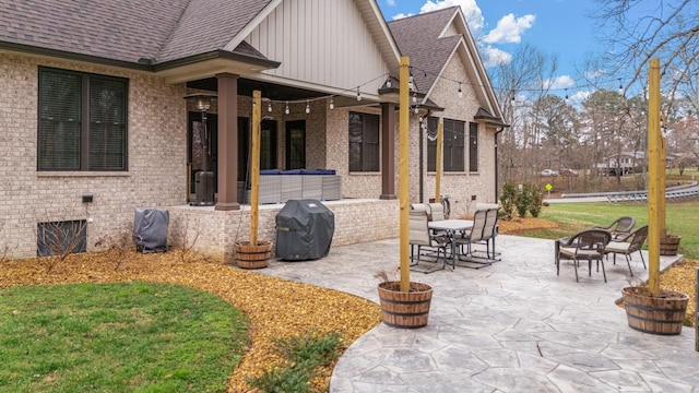 view of patio with an outdoor living space with a fire pit and a grill