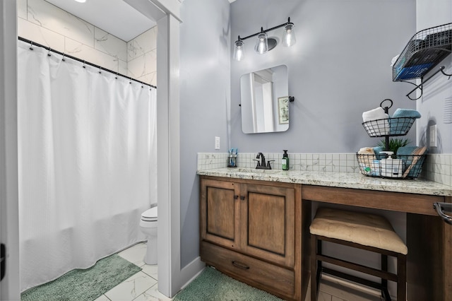 full bathroom featuring vanity, toilet, baseboards, and marble finish floor