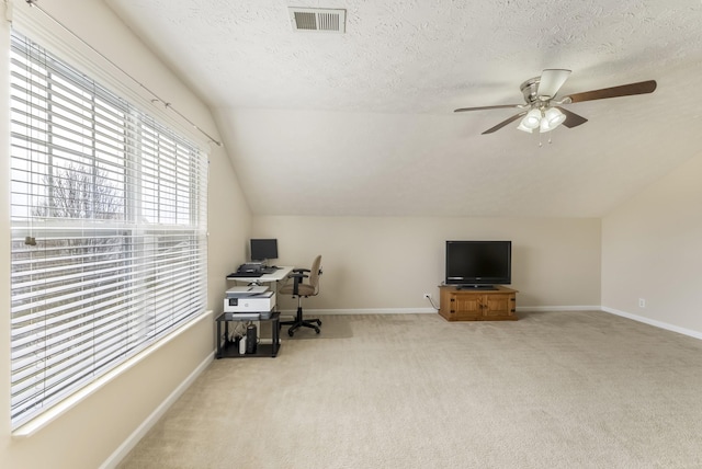 office with visible vents, light colored carpet, a ceiling fan, and a textured ceiling