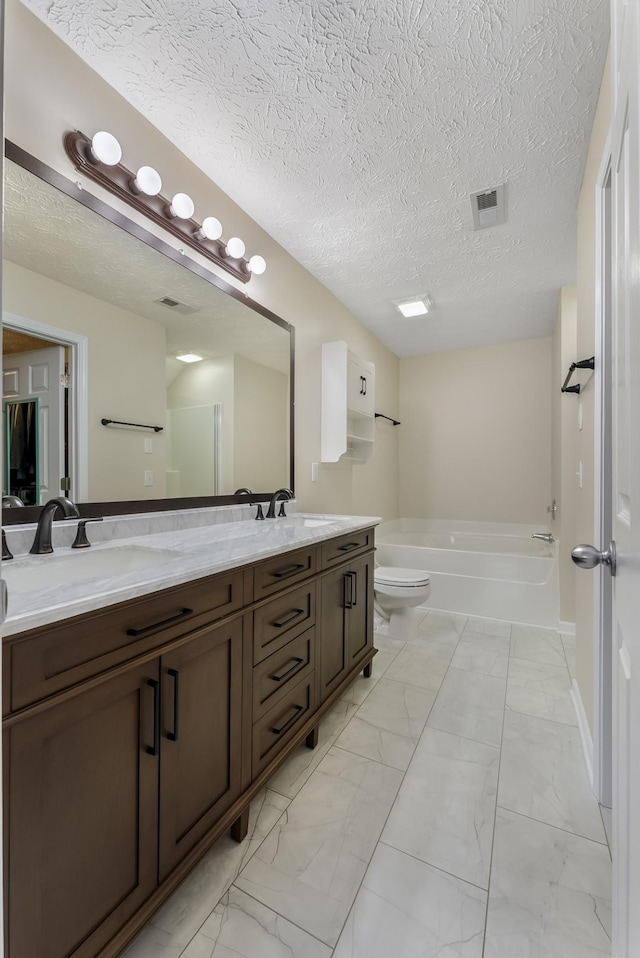 bathroom with double vanity, marble finish floor, and a sink