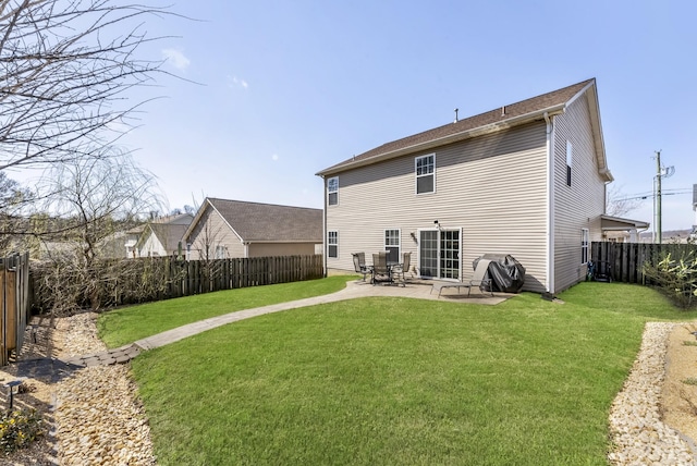 back of property with a lawn, a patio, and a fenced backyard