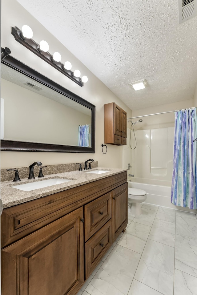 bathroom with double vanity, marble finish floor, shower / bath combo, and a sink