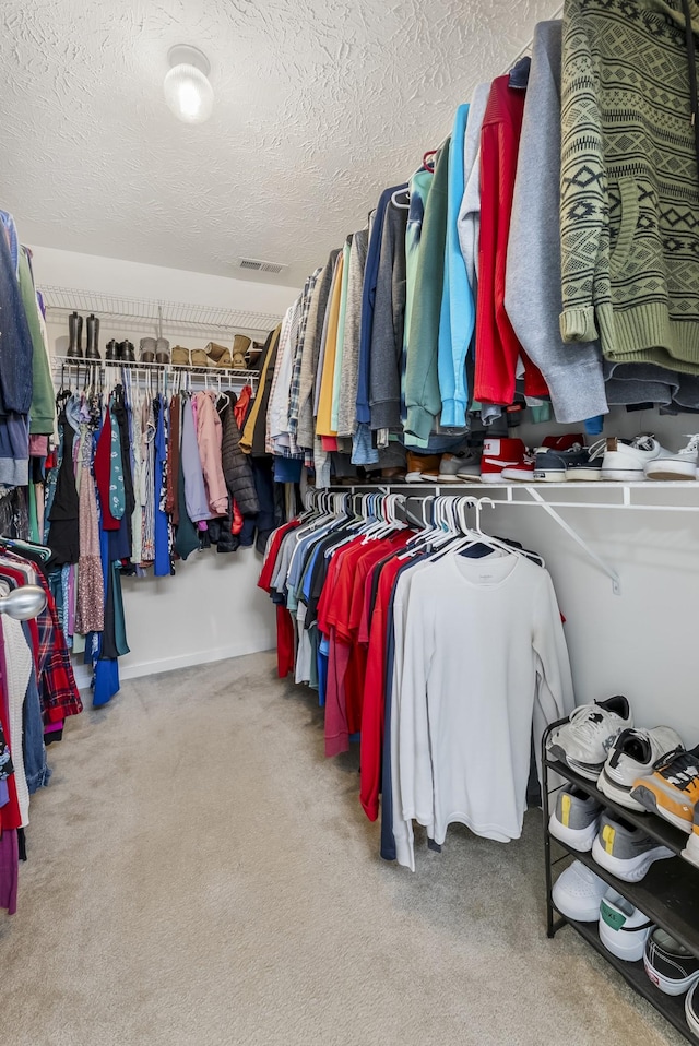 spacious closet with visible vents and carpet floors