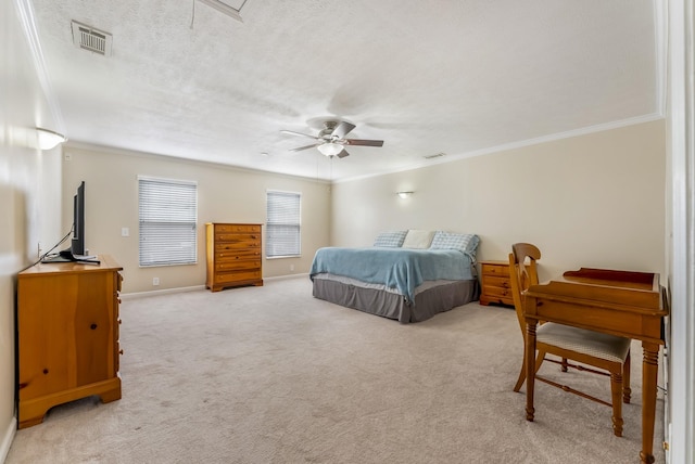 bedroom featuring a textured ceiling, ornamental molding, visible vents, and light carpet