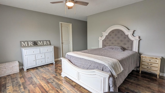 bedroom with a ceiling fan, wood finished floors, and baseboards