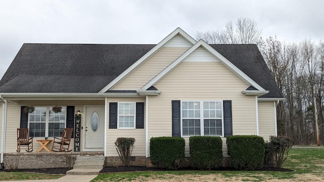 view of front of property with a porch and a shingled roof